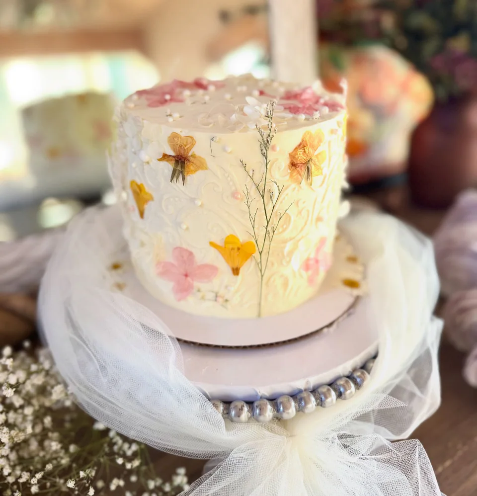 A two-tier cake with pressed floral decoration