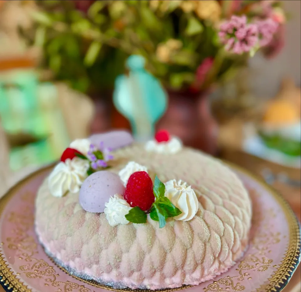 A lilac mousse cake finished with berries