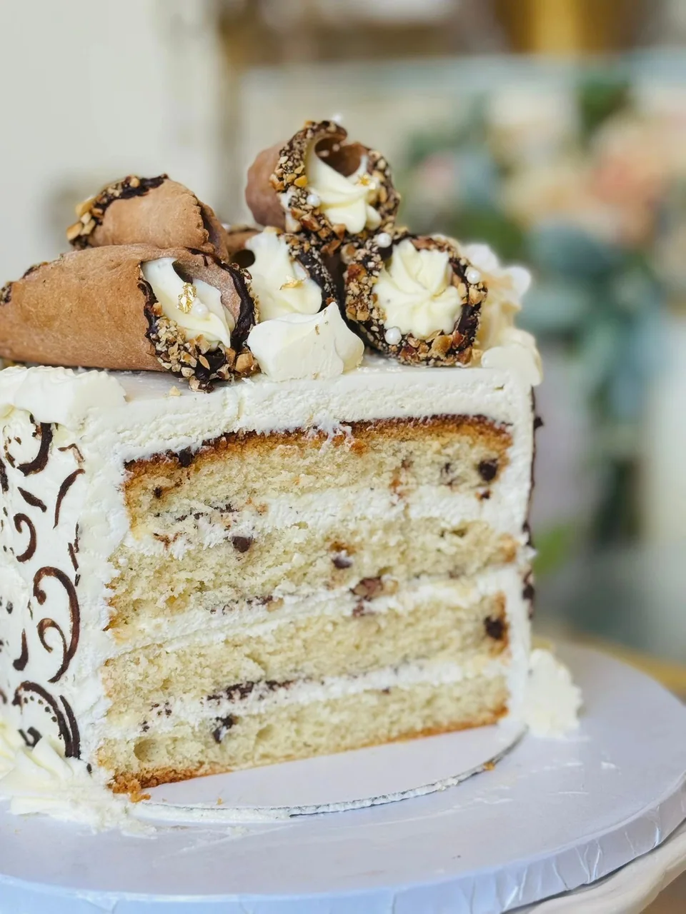 A cream-layered cake with a chocolate topping