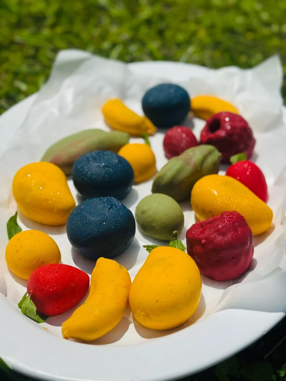 An assortment of berry and fruit-shaped pastries